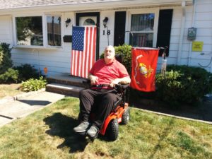 Roy Sherman poses with his new all terrain wheelchair.